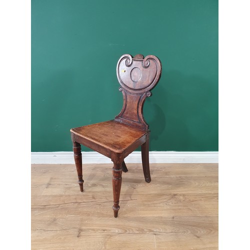 63 - A 1920's oak Elbow Chair with arched top rail having inlaid circular panel. vertical rail back, upho... 