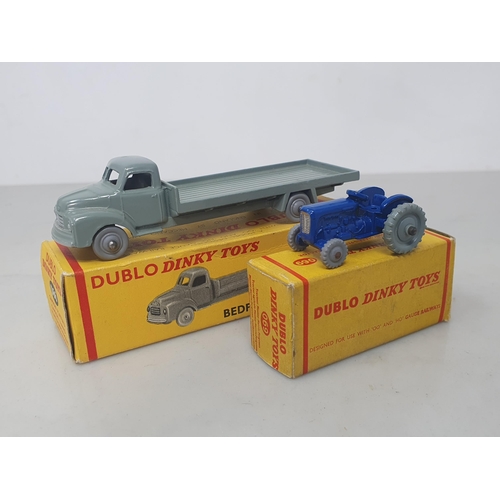 19 - A boxed Dublo Dinky Toys 066 Bedford Flat Truck and 069 Tractor, mint. Both vehicles in mint conditi... 