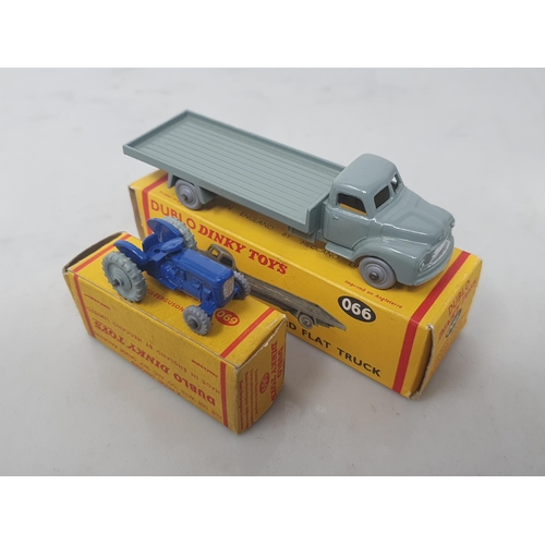 19 - A boxed Dublo Dinky Toys 066 Bedford Flat Truck and 069 Tractor, mint. Both vehicles in mint conditi... 