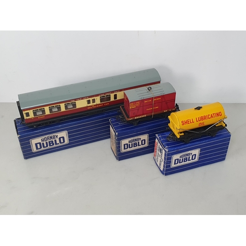 55 - A Hornby Dublo D1 'Shell' Tank Wagon, D1 Low-sided Wagon and D20 Restaurant Car in over sticker 3-ra... 