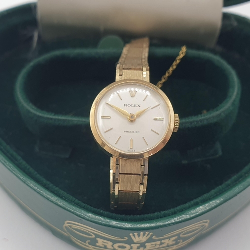 140 - A lady's Rolex Precision Wristwatch the white dial with hourly baton markers in 9ct gold case on 9ct... 