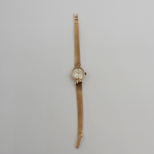 154 - A lady's Candino manual wind Wristwatch the silvered dial with hourly baton markers in 18ct gold cas... 