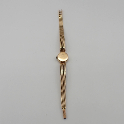 154 - A lady's Candino manual wind Wristwatch the silvered dial with hourly baton markers in 18ct gold cas... 