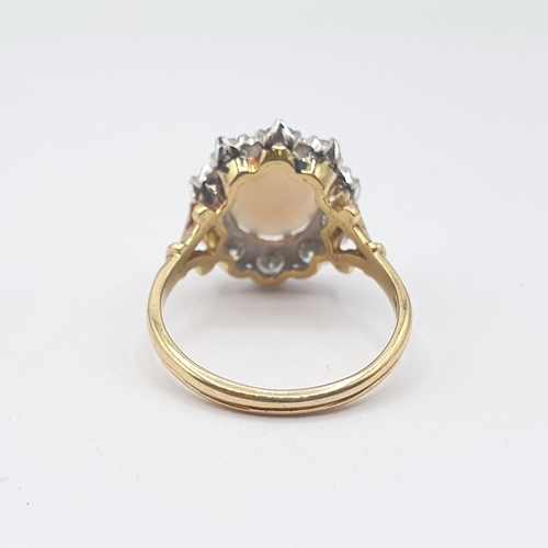 171 - An Opal and Diamond Cluster Ring claw-set oval opal cabochon within frame of ten brilliant-cut diamo... 