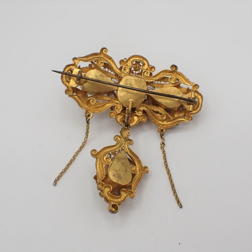 193 - A Victorian gilt metal filigree Brooch set foil backed red paste with detachable drop