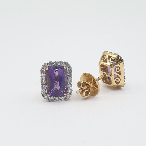 199 - A pair of Amethyst and Diamond Cluster Earrings each corner claw-set step-cut amethyst within a fram... 