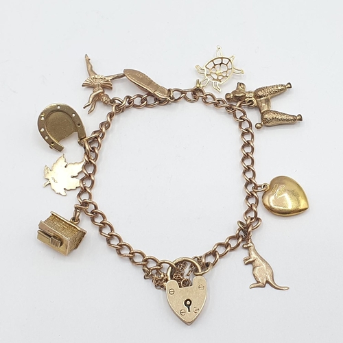 203 - A 9ct gold fine curb link Bracelet on padlock fastener suspending mostly 9ct gold charms, approx 19.... 