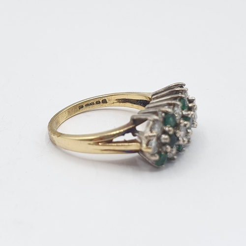 207 - An Emerald and Diamond Cluster Ring peg-set three rows of alternating round emeralds and brilliant-c... 