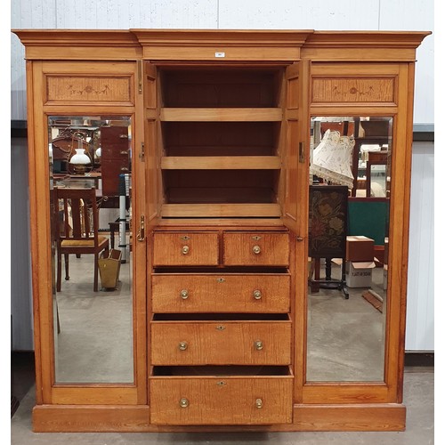 613 - A Victorian ash and satinwood Wardrobe with urn and swag inlay, fitted pair of mirror doors flanking... 