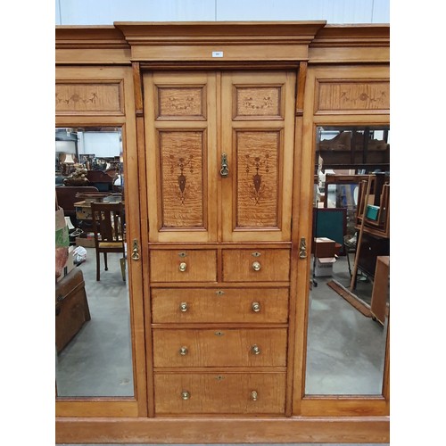 613 - A Victorian ash and satinwood Wardrobe with urn and swag inlay, fitted pair of mirror doors flanking... 