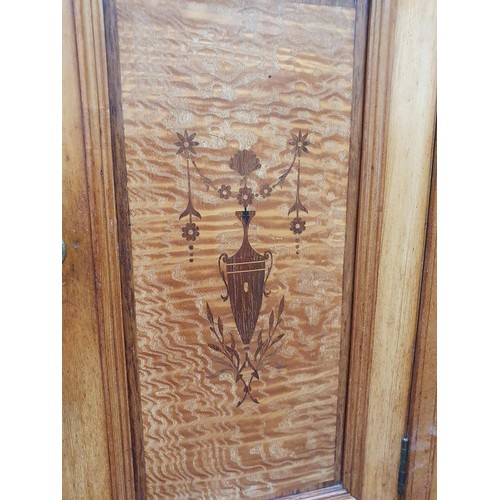 613 - A Victorian ash and satinwood Wardrobe with urn and swag inlay, fitted pair of mirror doors flanking... 