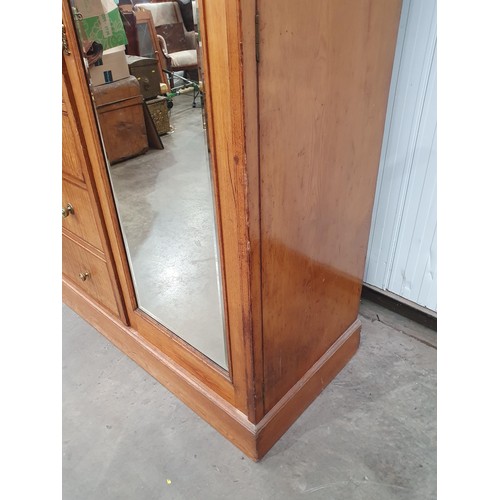 613 - A Victorian ash and satinwood Wardrobe with urn and swag inlay, fitted pair of mirror doors flanking... 