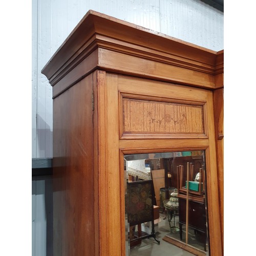 613 - A Victorian ash and satinwood Wardrobe with urn and swag inlay, fitted pair of mirror doors flanking... 