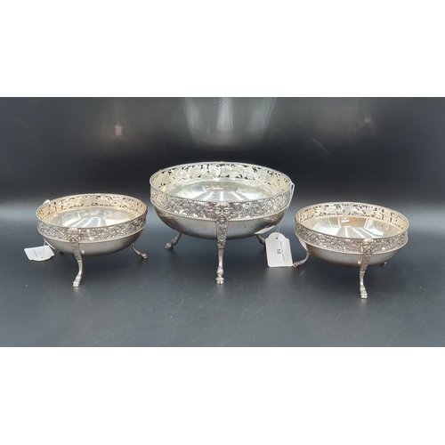 10 - A Garniture of three early 20th Century circular Bowls with pierced fruiting vine and bead friezes, ... 