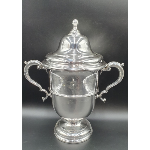 100 - A George V silver two handled Trophy and Cover engraved 