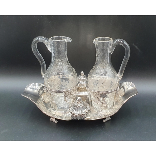 115 - An 18th Century French silver twin Oil Bottle Holder with pierced scroll design, scroll feet, fitted... 