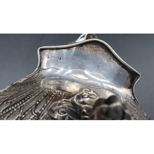 12 - A Continental silver scallop shape Dish with dolphin handle on three scroll supports