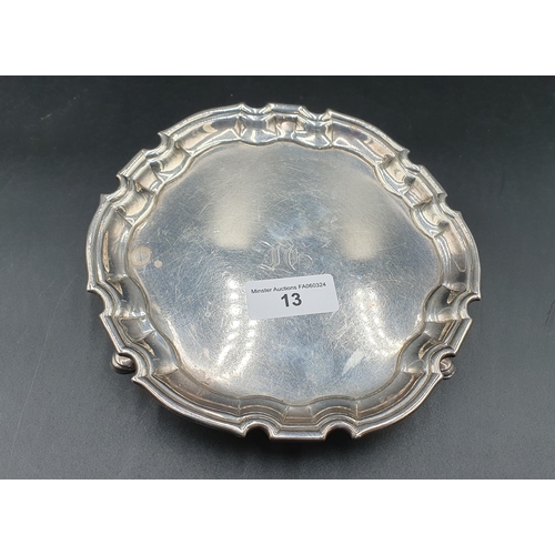 13 - A George II silver Card Tray of shaped circular form engraved initials, on three hoof feet, London 1... 