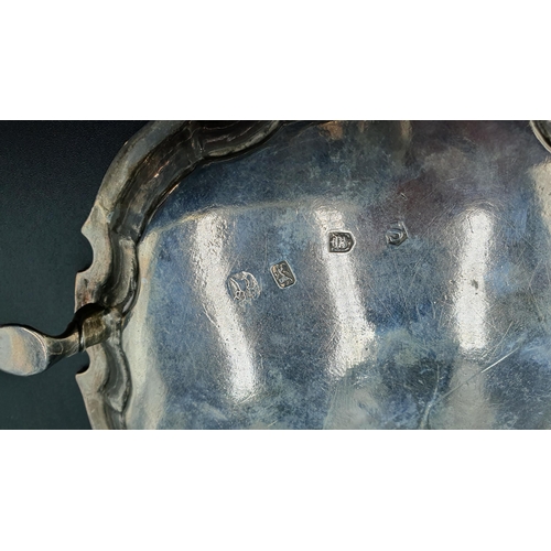 13 - A George II silver Card Tray of shaped circular form engraved initials, on three hoof feet, London 1... 