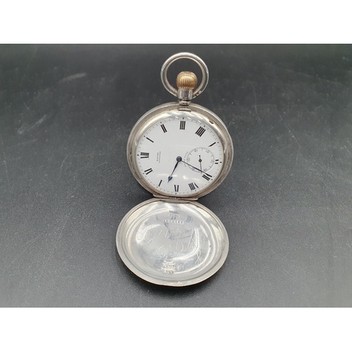 152 - A Baume Longines silver cased Hunter Pocket Watch with white enamel dial and subsidiary seconds dial... 