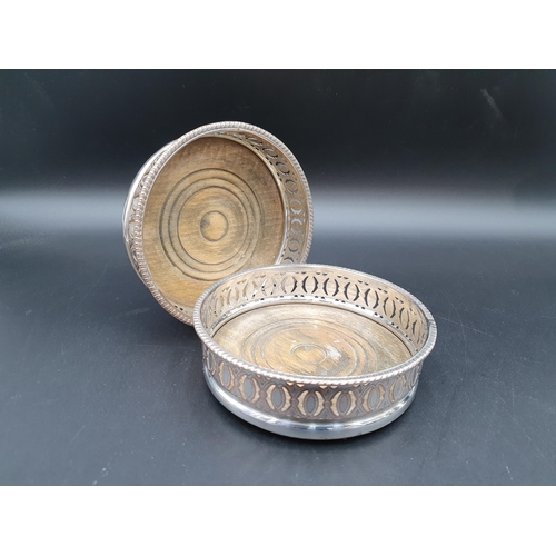 16 - A pair of Sheffield plated pierced circular Coasters with turned wooden bases, a plated Trophy decor... 