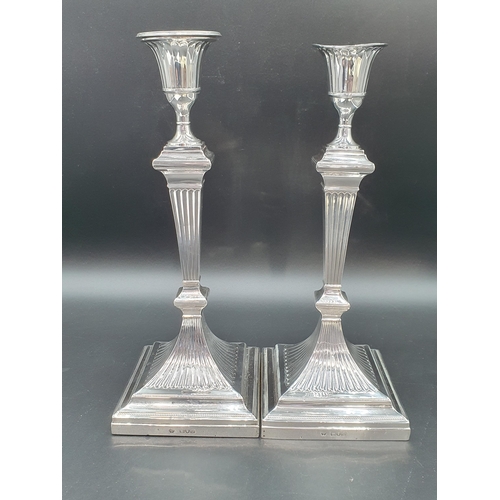 23 - A pair of Victorian silver Pillar Candlesticks with fluted tapering columns on square bases, London ... 