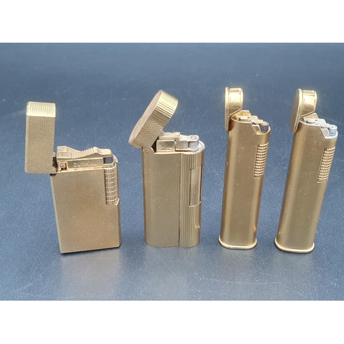 243 - Four Dunhill Cigarette Lighters in gold plated cases