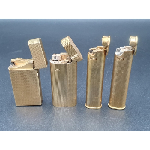 243 - Four Dunhill Cigarette Lighters in gold plated cases