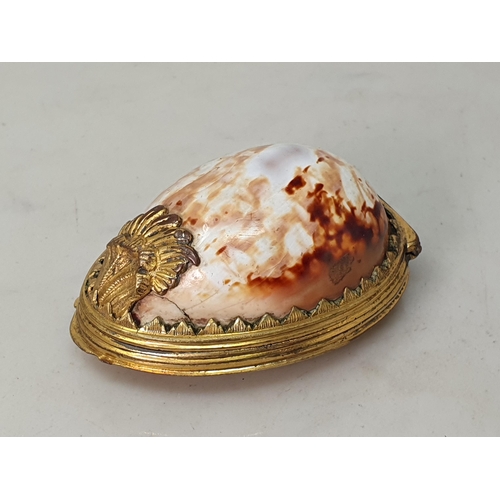 244 - An 18th Century Cowrie Shell box with gilded metal lid with relief design of Phoenix 3 1/4in L