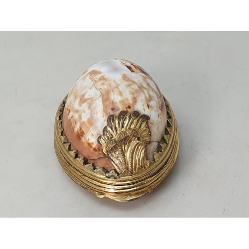 244 - An 18th Century Cowrie Shell box with gilded metal lid with relief design of Phoenix 3 1/4in L