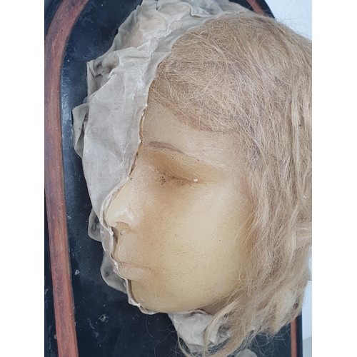 248 - A Victorian wax Death Mask of a girl on ebonised dome base 1ft 7in W