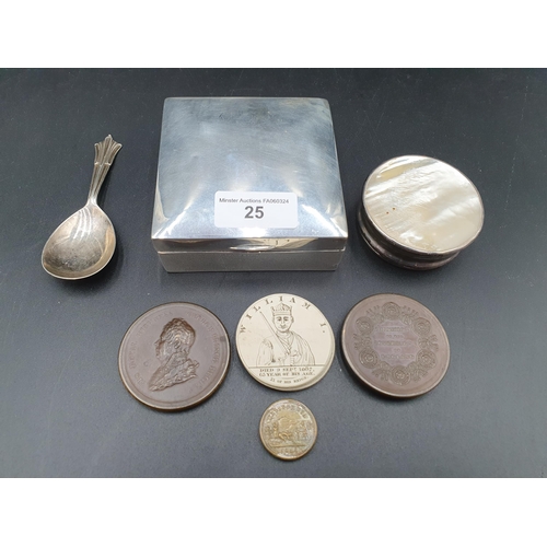 25 - A George V silver square Cigarette Box, London 1919, a Caddy Spoon, Sheffield 1938, a white metal ci... 