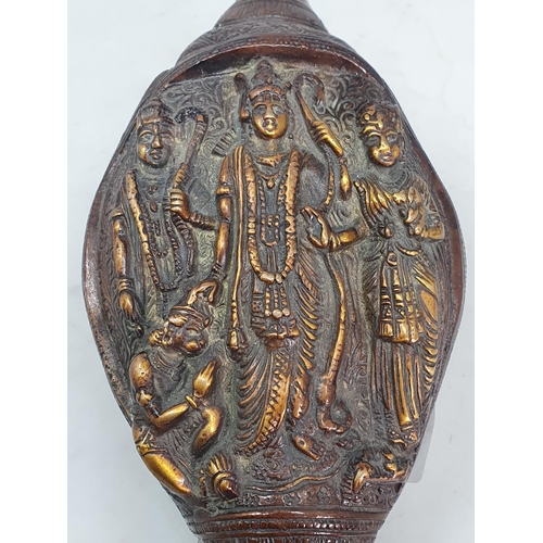 308 - An Oriental patinated bronze Deity Shell with scrolled and floral decorations, with four Religious F... 