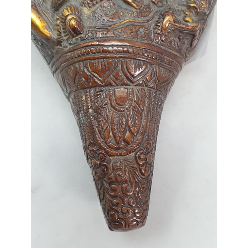 308 - An Oriental patinated bronze Deity Shell with scrolled and floral decorations, with four Religious F... 