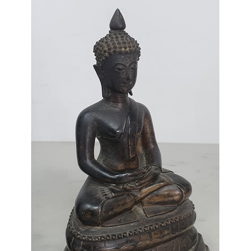 310 - A bronze Buddha in the seated position on decorative base, 6