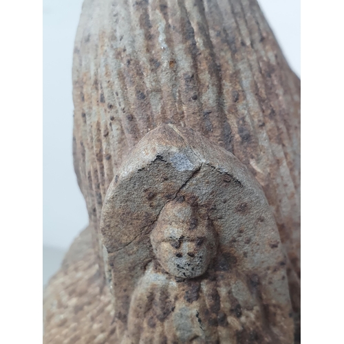 311 - A carved stone Buddha Head with later carved wooden associated Stand. A/F. (Head alone measures 11