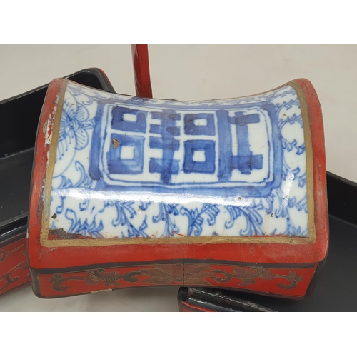 313 - A Chinese three tier lacquered Tiffin Carrier, the lid with inset blue and white tile, with red lacq... 