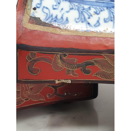 313 - A Chinese three tier lacquered Tiffin Carrier, the lid with inset blue and white tile, with red lacq... 