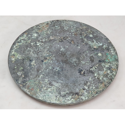 320 - A patinated Chinese bronze circular Mirror/Roundel with fruiting vine, bird and beast border, the ce... 