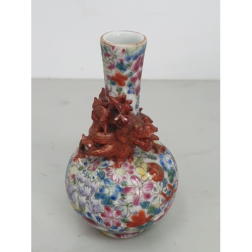 321 - A Chinese Mille Fleur Dragon bottle Vase of small form, with a dragon chasing a flaming pearl around... 