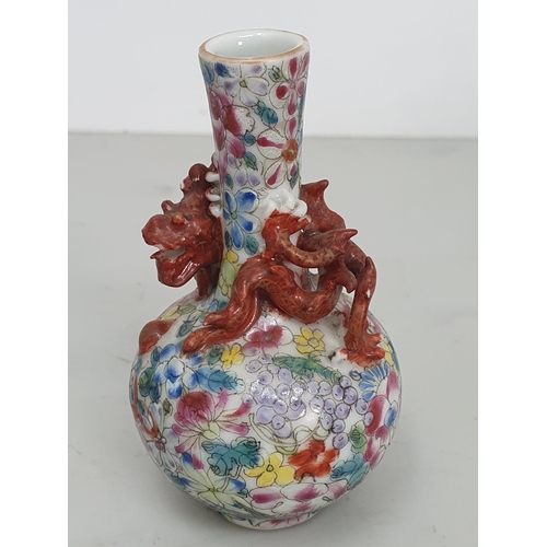 321 - A Chinese Mille Fleur Dragon bottle Vase of small form, with a dragon chasing a flaming pearl around... 