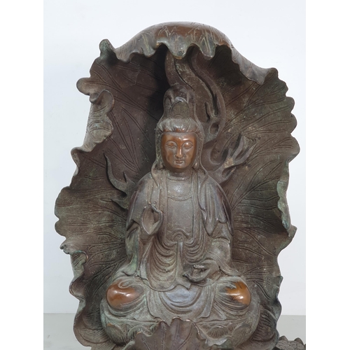 329 - A bronze Figure of a Seated Guan Yin Buddha in Lotus Leaf, 10.5