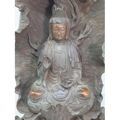 329 - A bronze Figure of a Seated Guan Yin Buddha in Lotus Leaf, 10.5