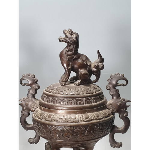 330 - A pair of Chinese bronze Temple Urns and Covers with Kylin finials, the urns on three serpent suppor... 