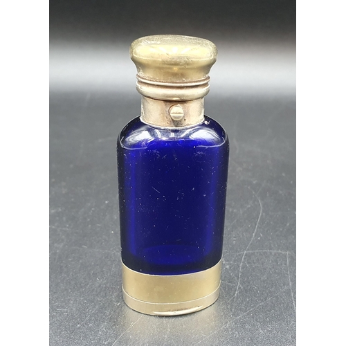 34 - A Victorian silver-gilt mounted blue glass Scent Bottle/Vinaigrette with finely scroll pierced and e... 