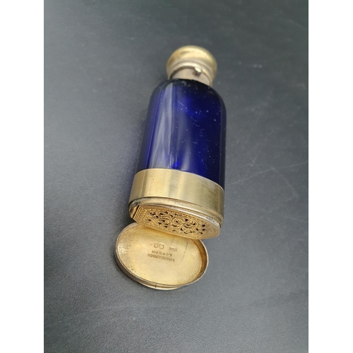 34 - A Victorian silver-gilt mounted blue glass Scent Bottle/Vinaigrette with finely scroll pierced and e... 