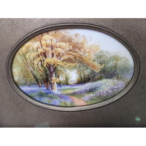 356 - A Royal Worcester Plaque having blue bells in a woodland scene, signed Rushton, framed with oval ape... 