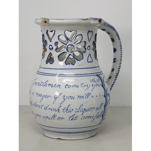 368 - A Delft blue and white Puzzle Jug painted Birds, Flowers and Verse, with pierced neck, A/F, 7.5