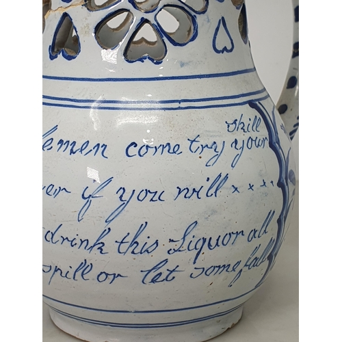 368 - A Delft blue and white Puzzle Jug painted Birds, Flowers and Verse, with pierced neck, A/F, 7.5