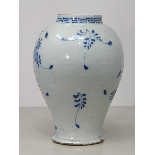 371 - An Antique blue and white Delft Baluster Vase, with Greek key style frieze, and floral and willow pa... 